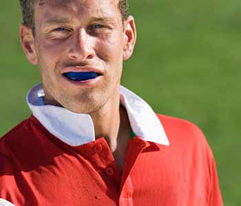 Custom-made sport mouth guards to protect the teeth from injury during athletic events.